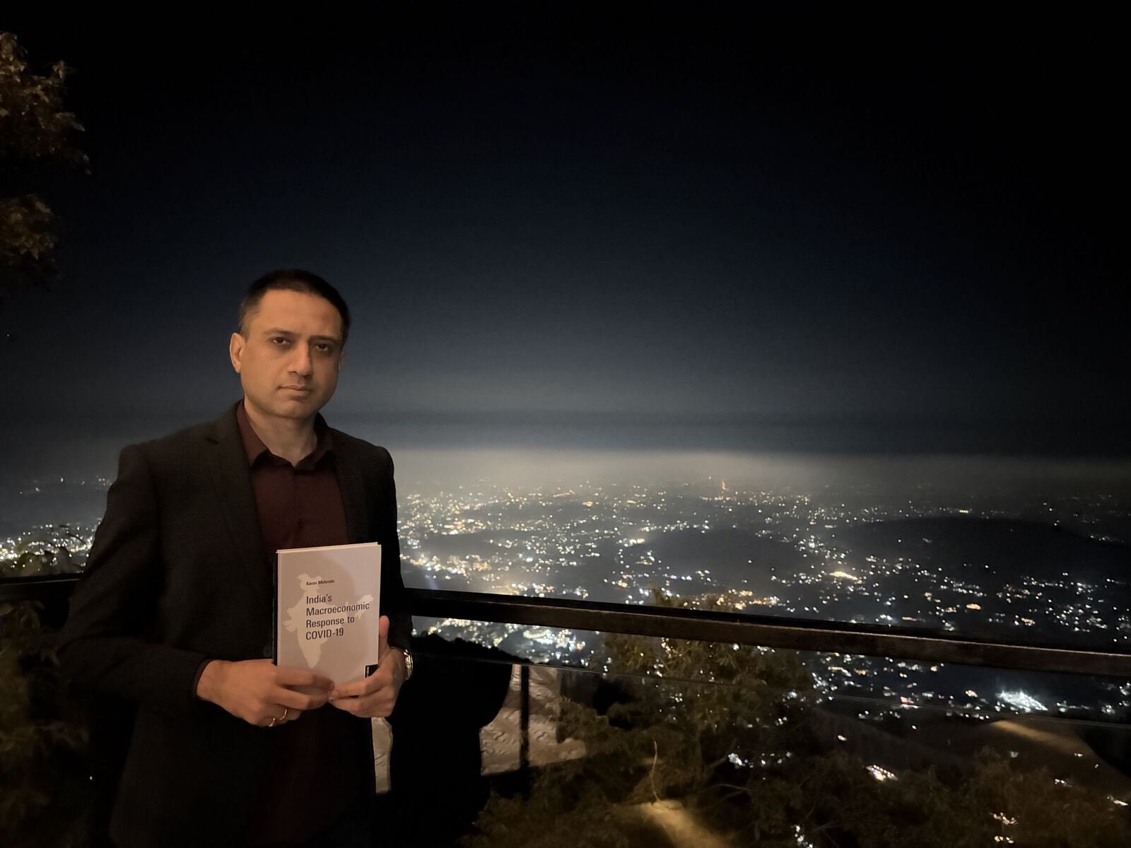 Karan Mehrishi with India's Macroeconomic Response to Covid-19, city lights below